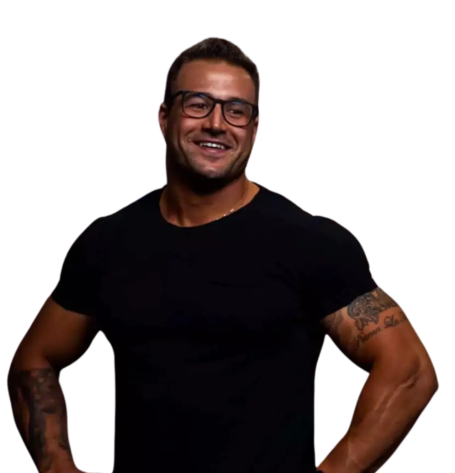 Ambrogio Castellana, owner of Ambrogio Fitness smiling with hands on hips in a fitted black tshirt